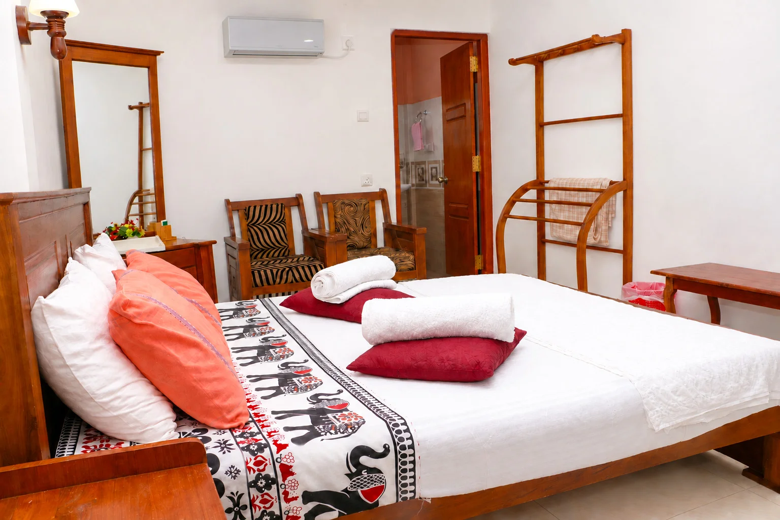 Deluxe Double Room 2 — Peaceful garden-facing bedroom with large queen bed and soft ambient decor