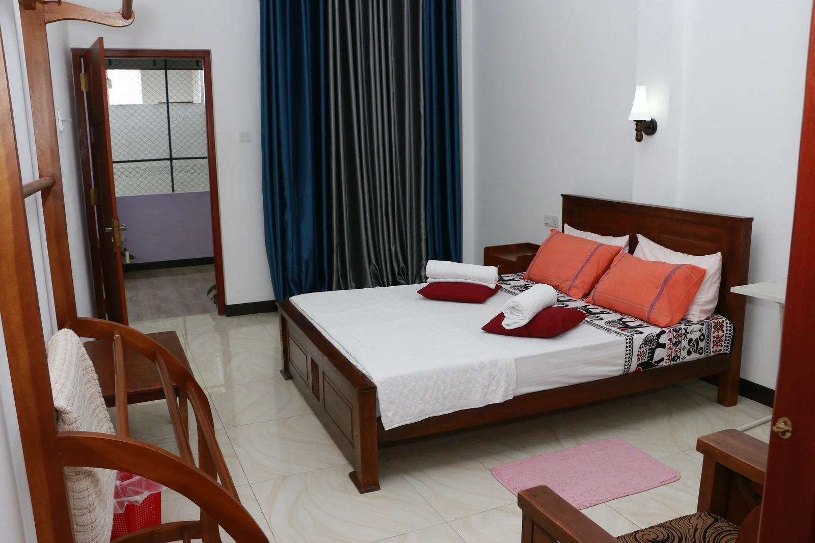 Deluxe Double Room 2 — Garden-side window view offering natural light and hill-country greenery