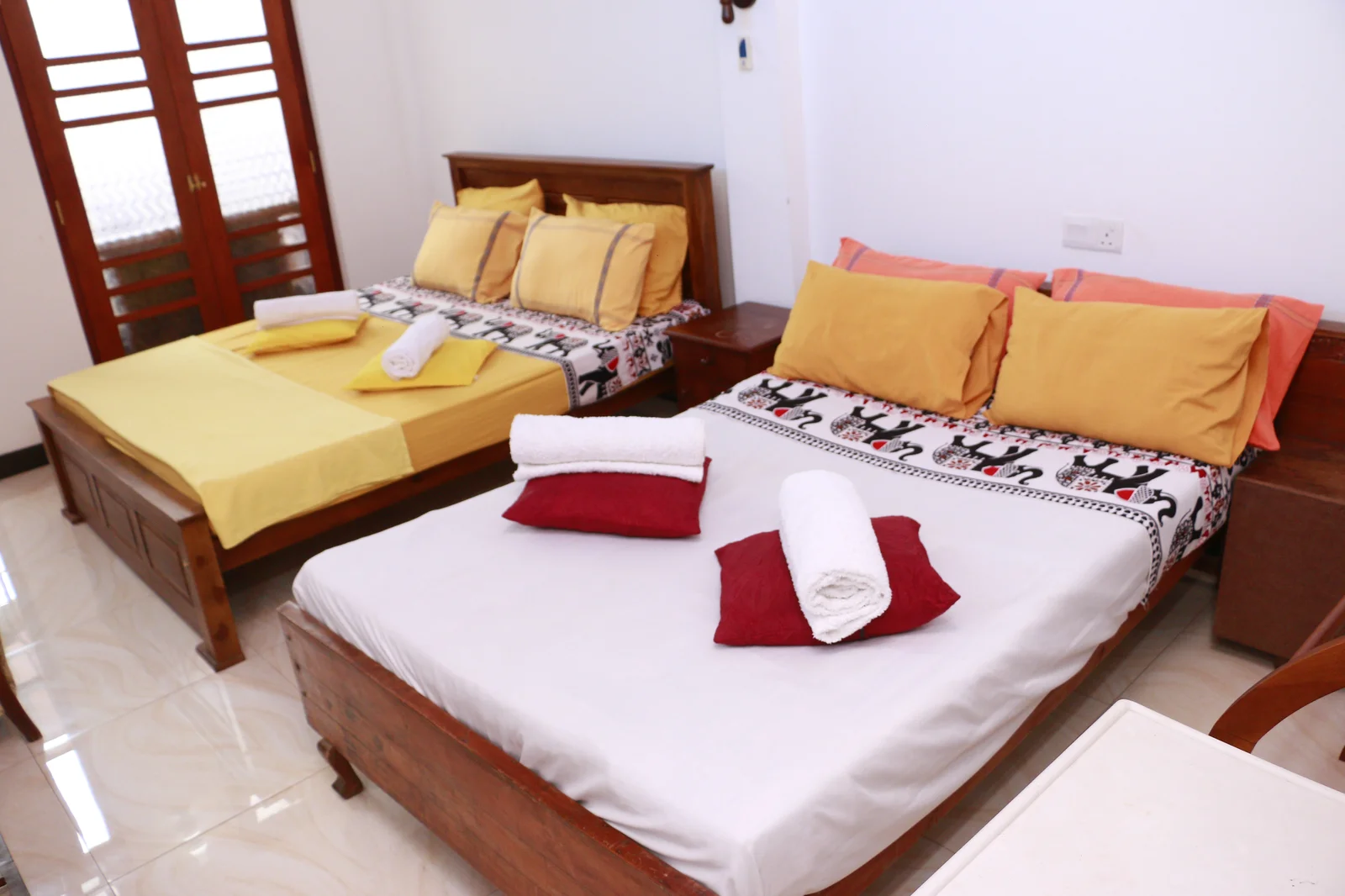 Deluxe Family Room — Peaceful bedroom setting arranged for restful family and couple stays